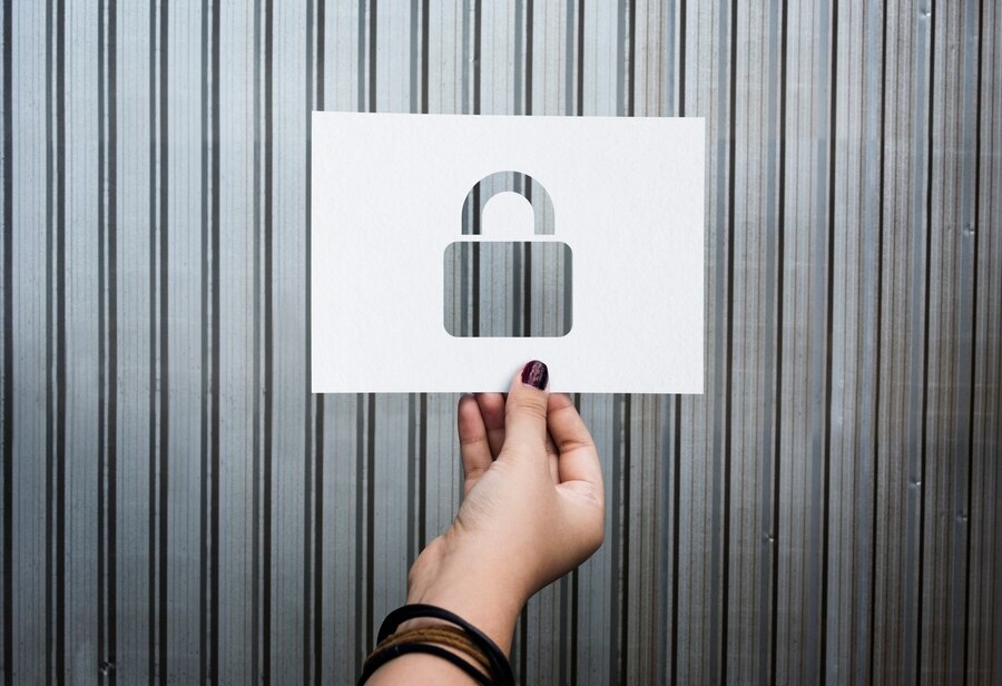 hand holding paper with padlock-shaped hole.